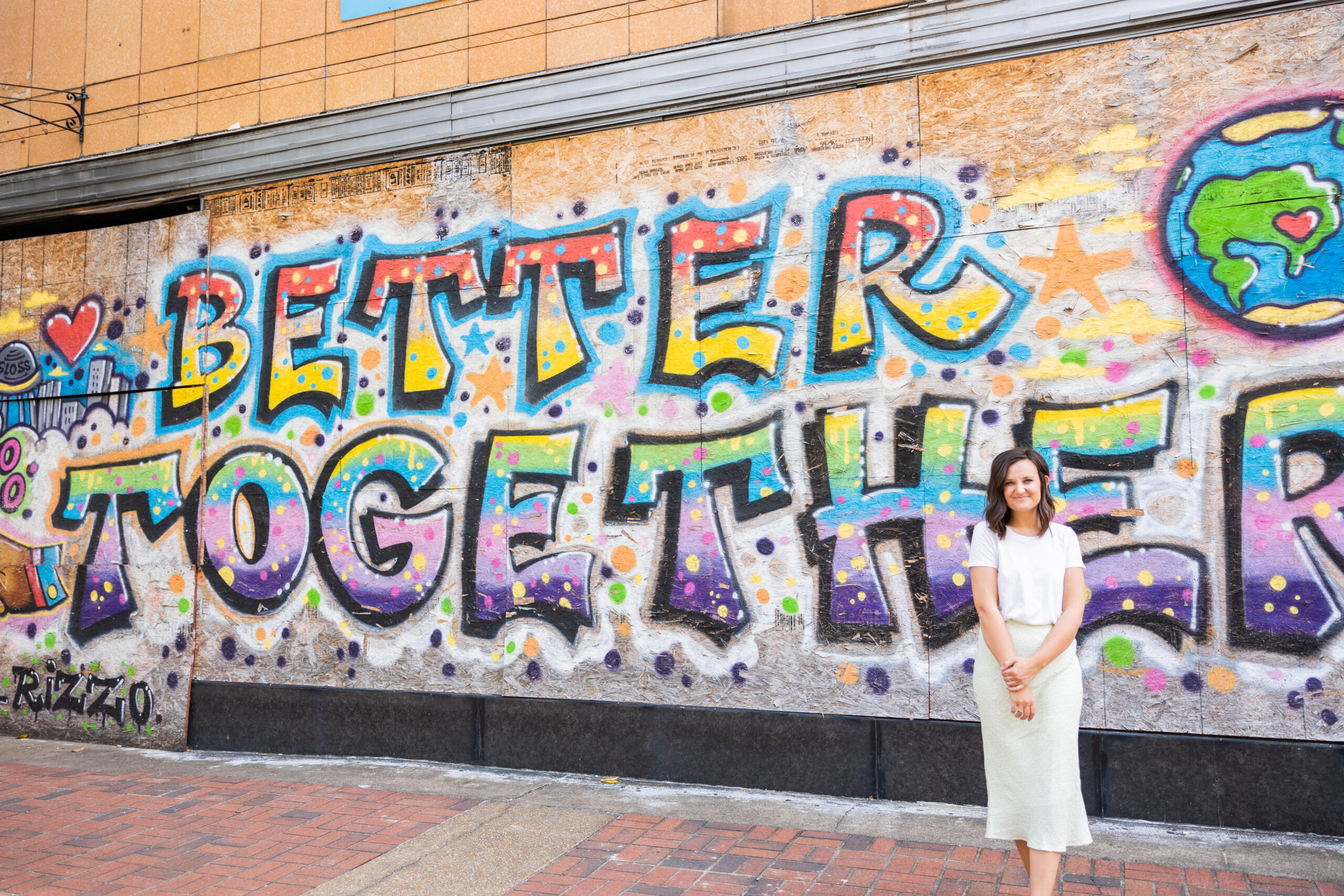 Eleanor Stenner photographed in front of Birmingham murals.