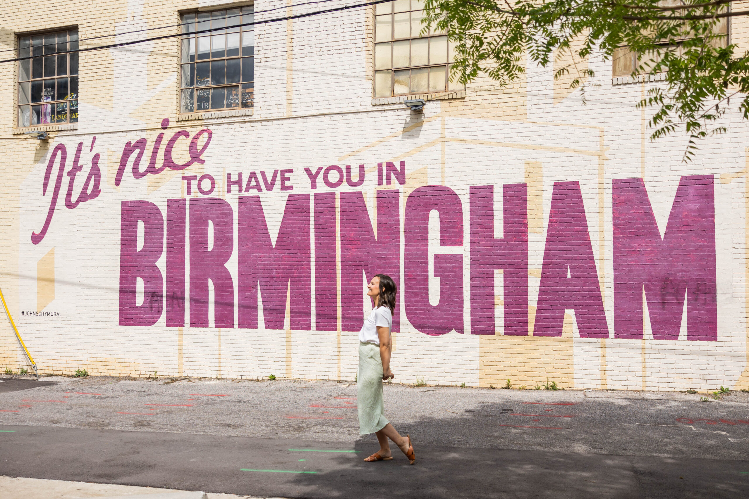 Eleanor Stenner photographed in front of Birmingham murals. 