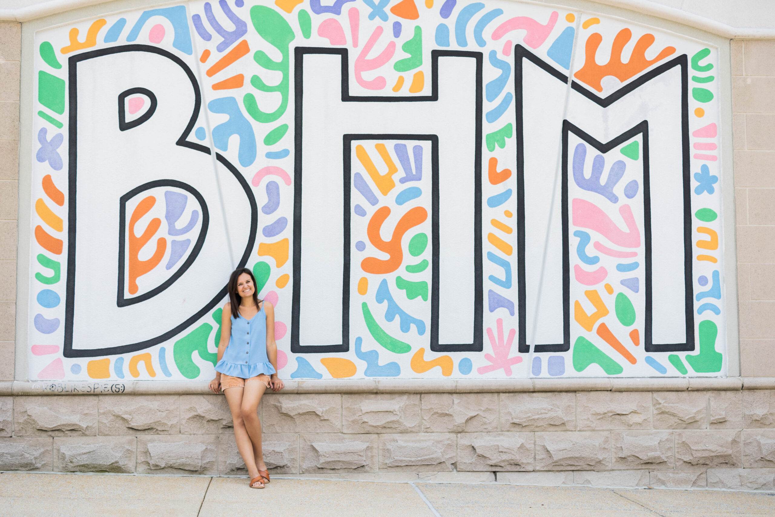 Eleanor Stenner photographed in front of Birmingham murals 