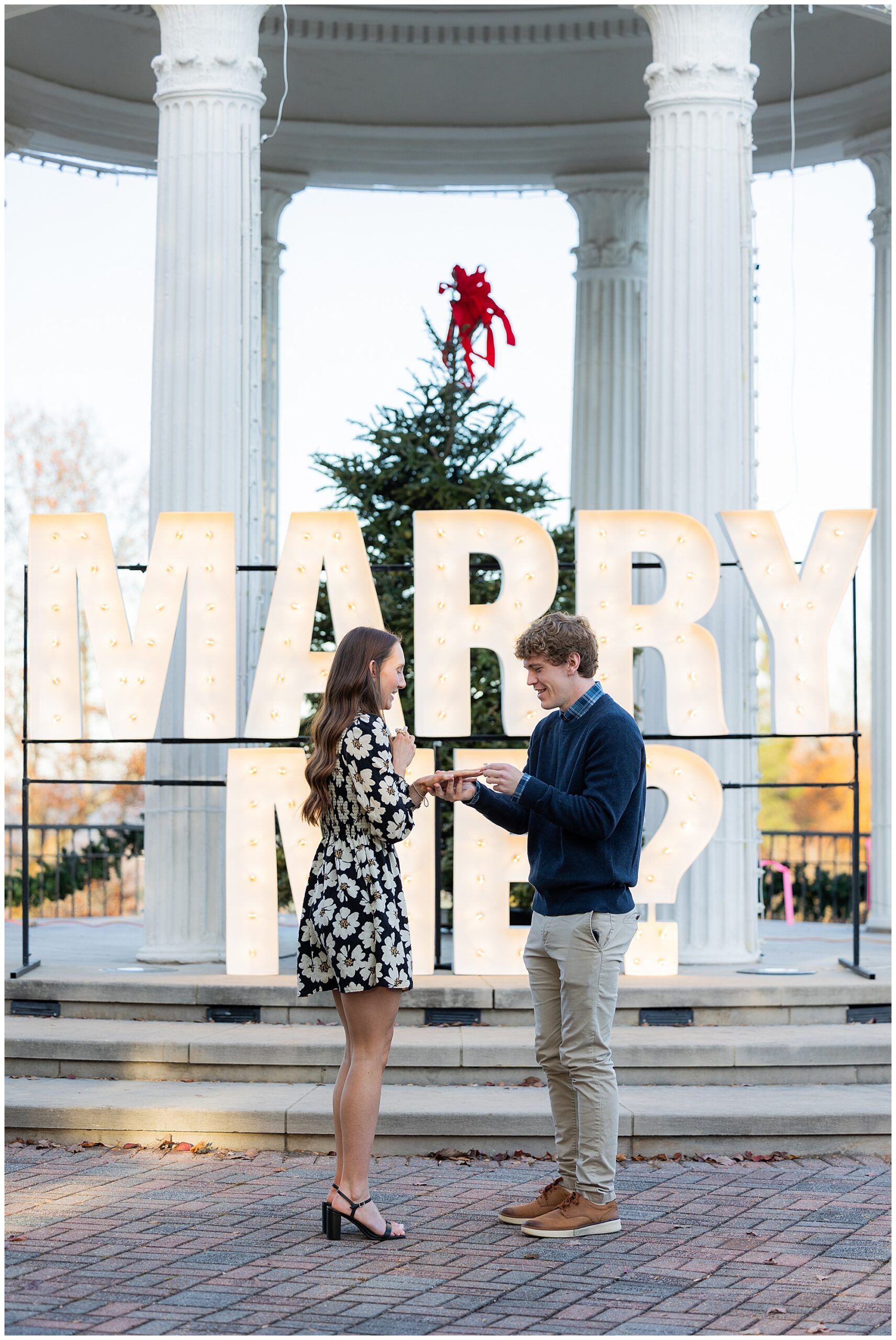 Camden slides the ring onto Olivia's finger. 