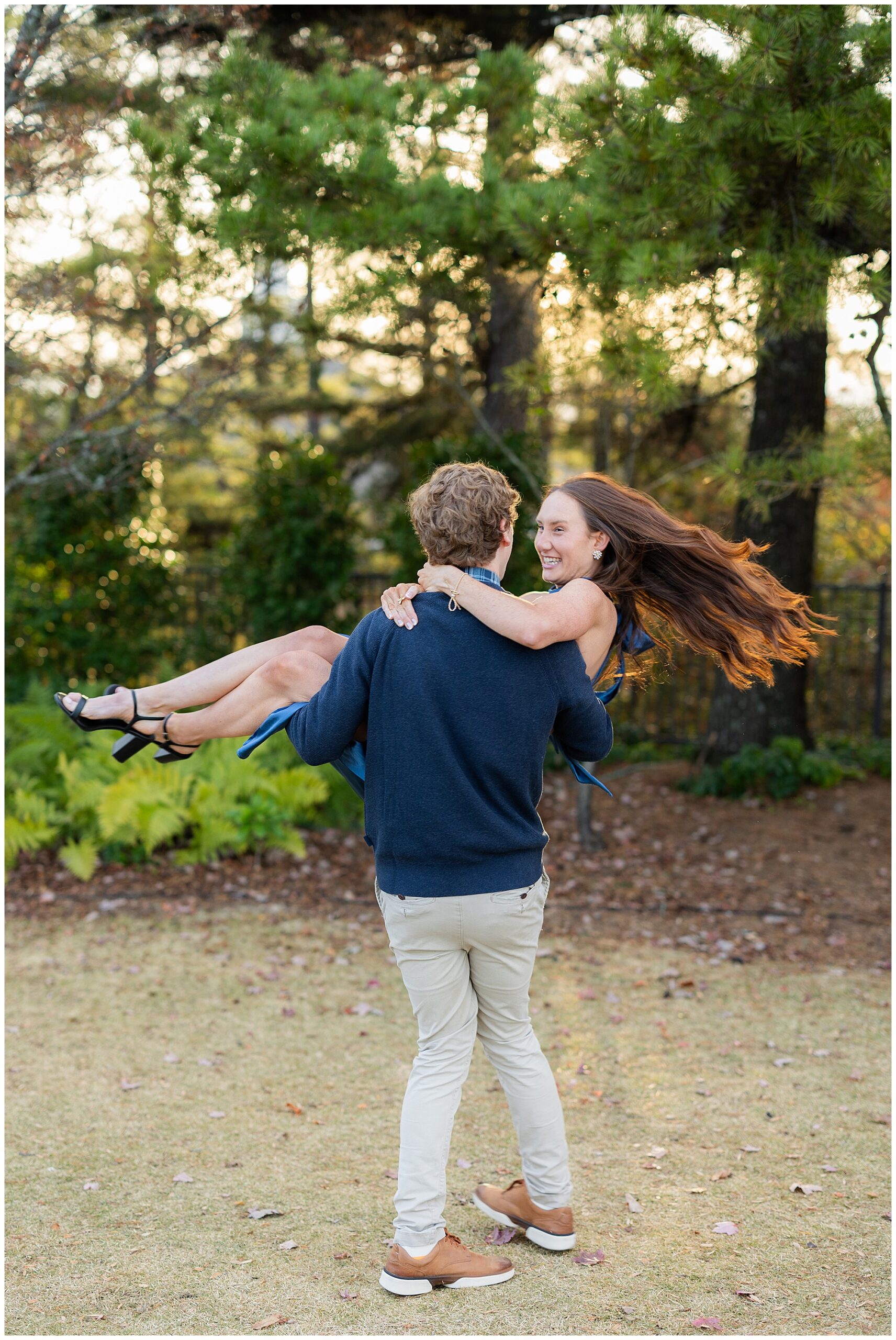 Camden picks Olivia up and spins her around in the air. 